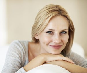 Closeup of comfortable middle aged woman sitting on couch at home