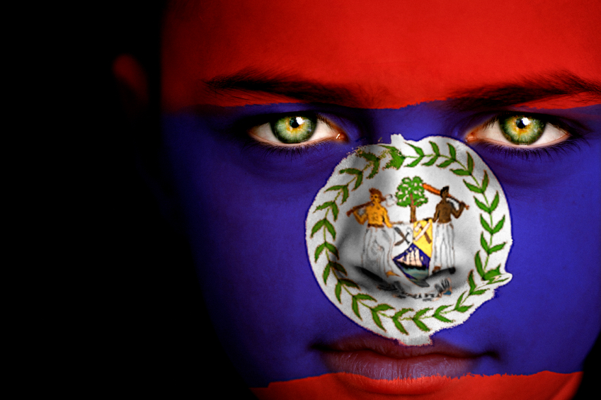 Portrait of a boy with the flag of Belize on his face.